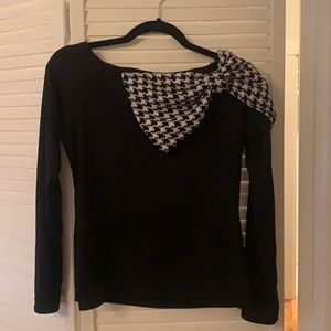 Black and stylish blouse with a bow